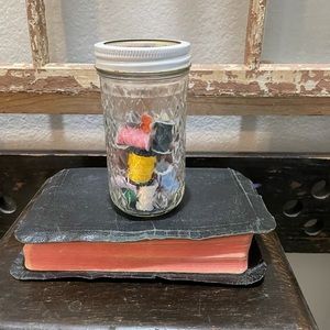Vintage threads in jar